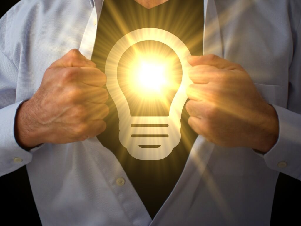 becoming a value chain superhero, man opening his shirt with a lightbulb shining on the front